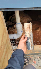Under-cabinet PVC pipe repair — wider view